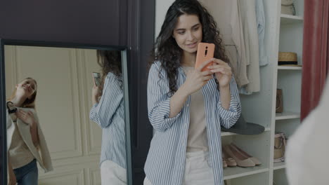 woman trying on clothes with a friend in a dressing room