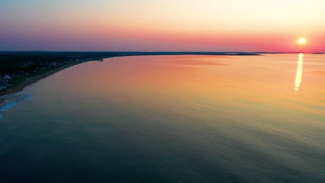 sunrise colors reflecting off ocean waves along the coastline