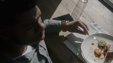 man eating a meal at a restaurant