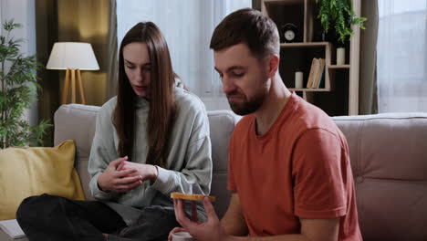 Couple-sitting-on-the-sofa-at-home