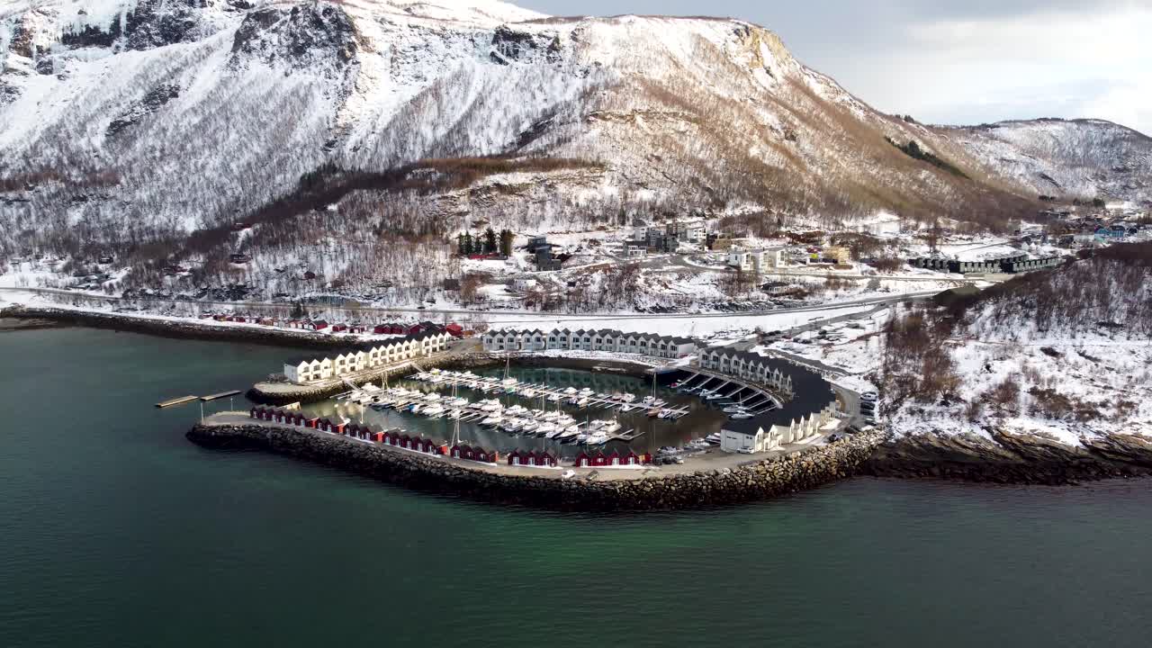 Experience the serene beauty of winter in Bodø, Norway, with this 4K drone footage. Snow-covered mountains, frozen fjords, and a beautiful norwegian harbour.