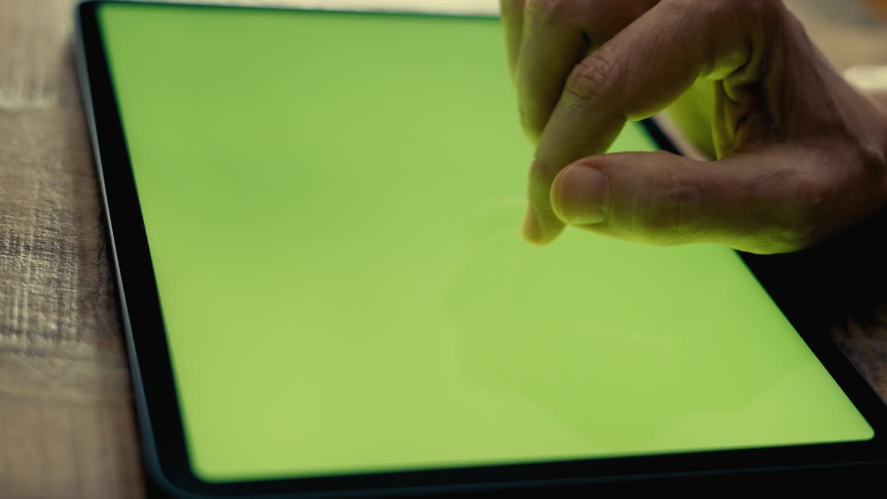 Hands using digital tablet with green screen