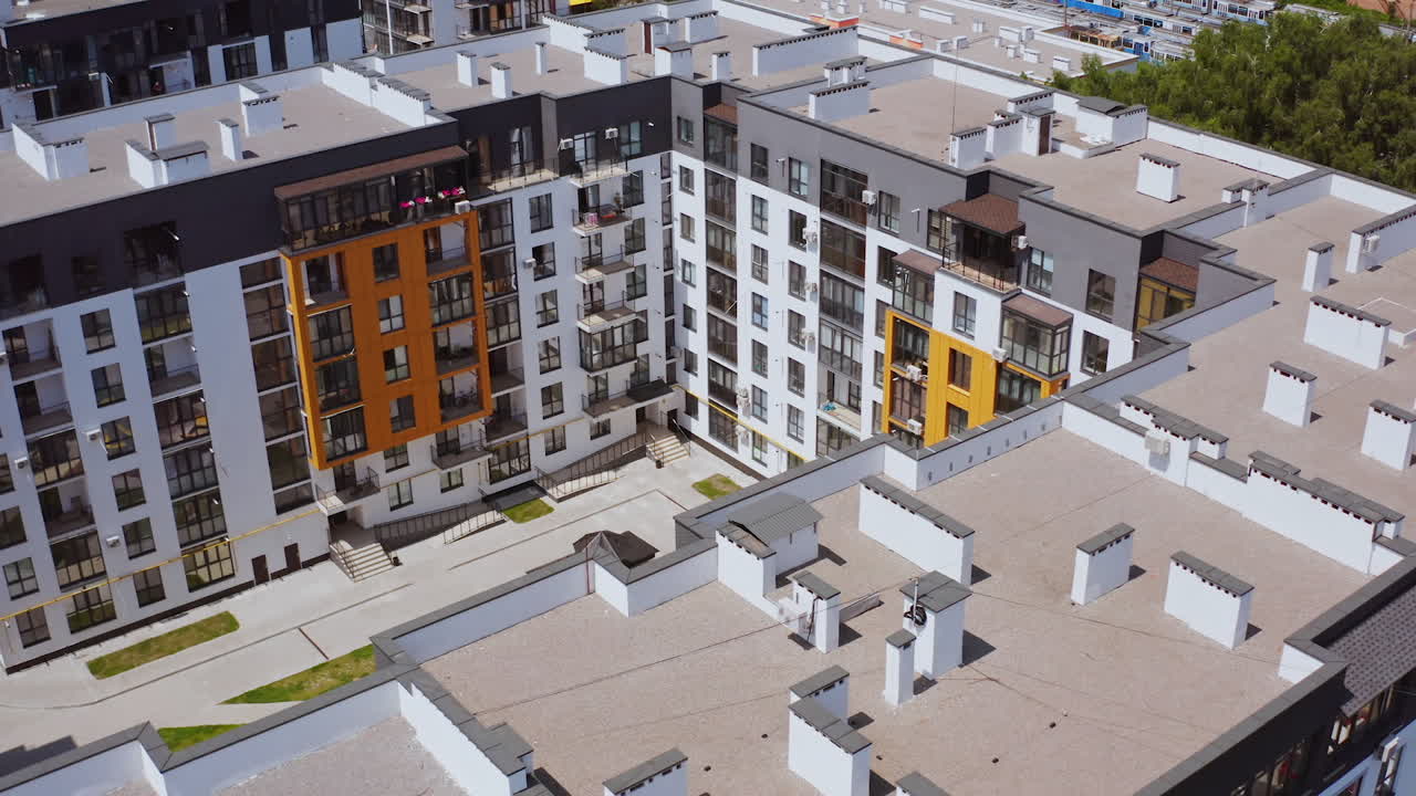 New residential complex. High-rise buildings built together. Comfortable playground for kids surrounded by apartment buildings. Top aerial view.