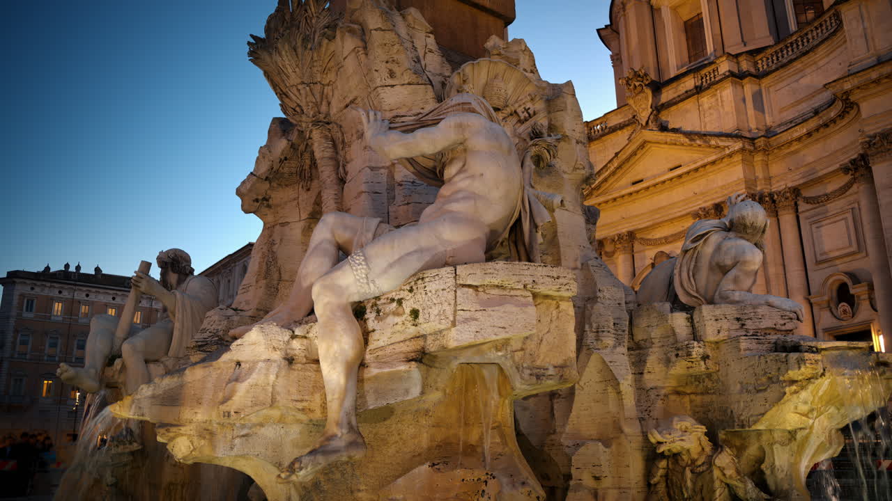 Fountain of the Four Rivers located in Navona square. Rome city square at sunset. Italy