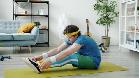man stretching and tying shoes at home