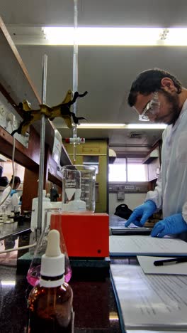 lab scientist with document and chemical setup