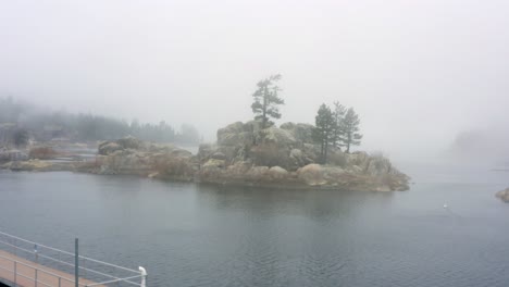 aerial 4k footage of big bear lake's shore with spooky fog