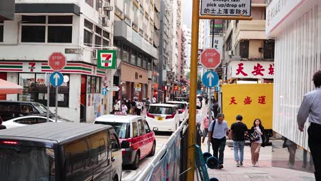 pedestrians and vehicles navigate bustling city street