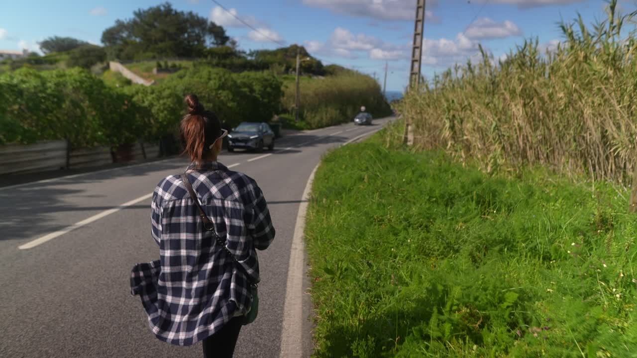 Woman Walking Along a Country Road