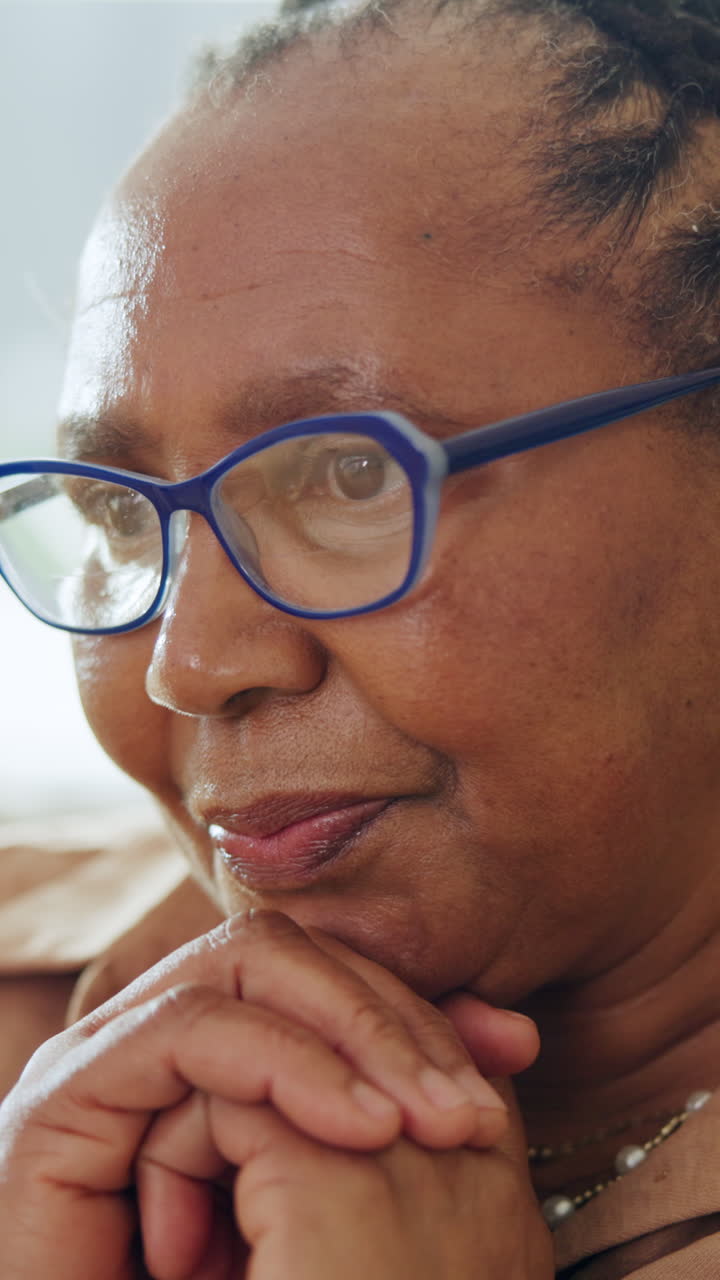 Close Up Portrait of a Thoughtful Senior Black Woman with Glasses