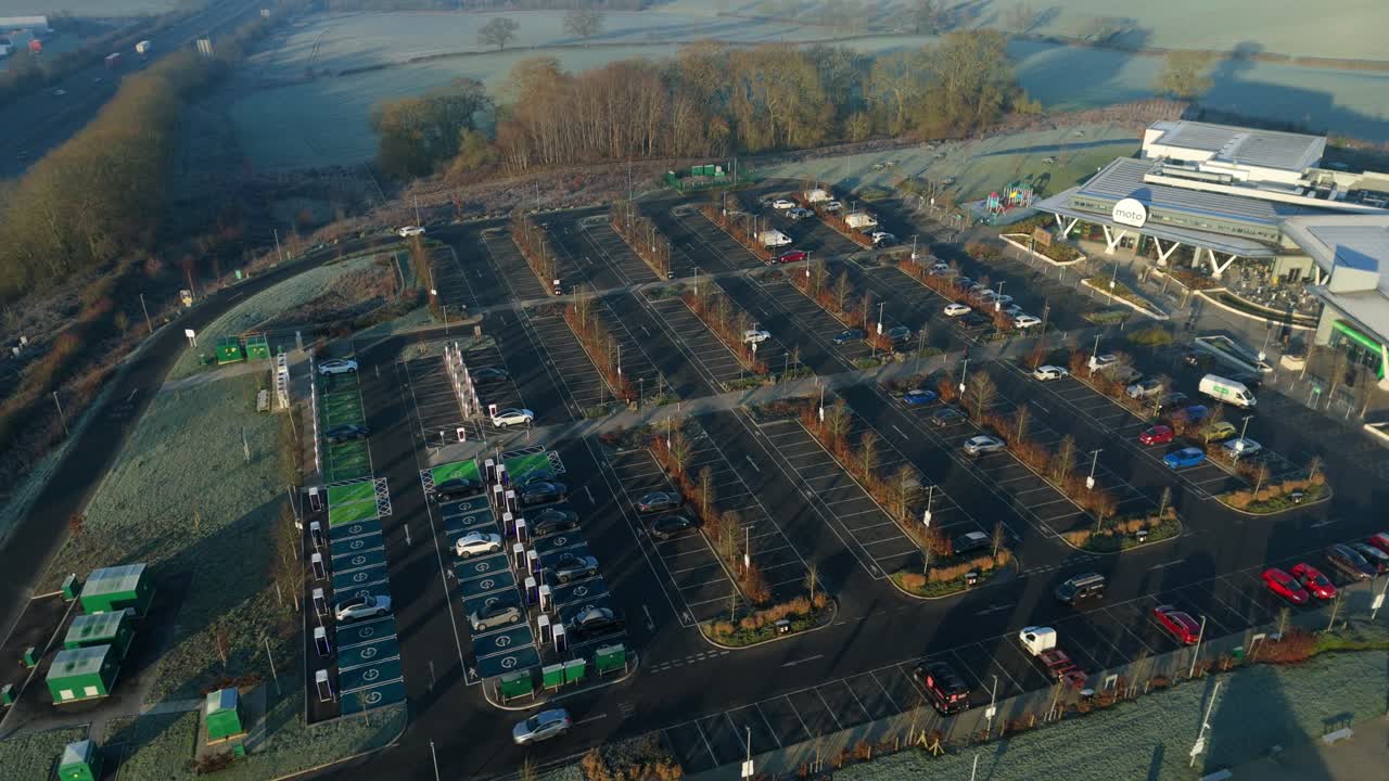 Aerial drone view of the ultra-rapid electric vehicle charging hub at Moto Rugby Services on the M6 motorway UK