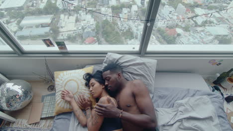 top down of young couple in love sleeping in bed