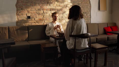 couple enjoying tea at a cozy cafe