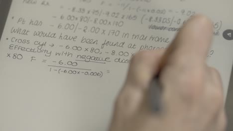 neat handwriting of optometry equations on smart tablet in slow motion
