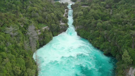 aerial drone descending shot of huka falls and raging waikato river near lake taupo, new zealand