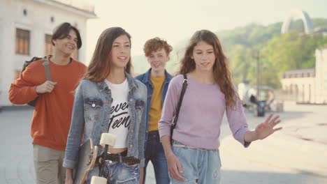 a group of teenagers walk down the street