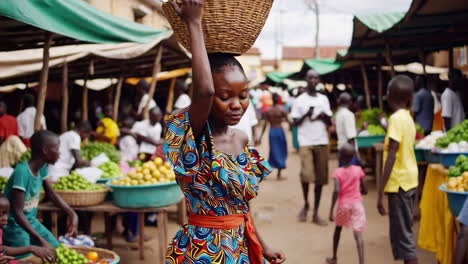 woman carrying basket of fruit at african market