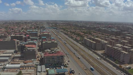 a drone shot of the kware settlement in nairobi's eastlands district showing many high rise residential buildings and a major highway