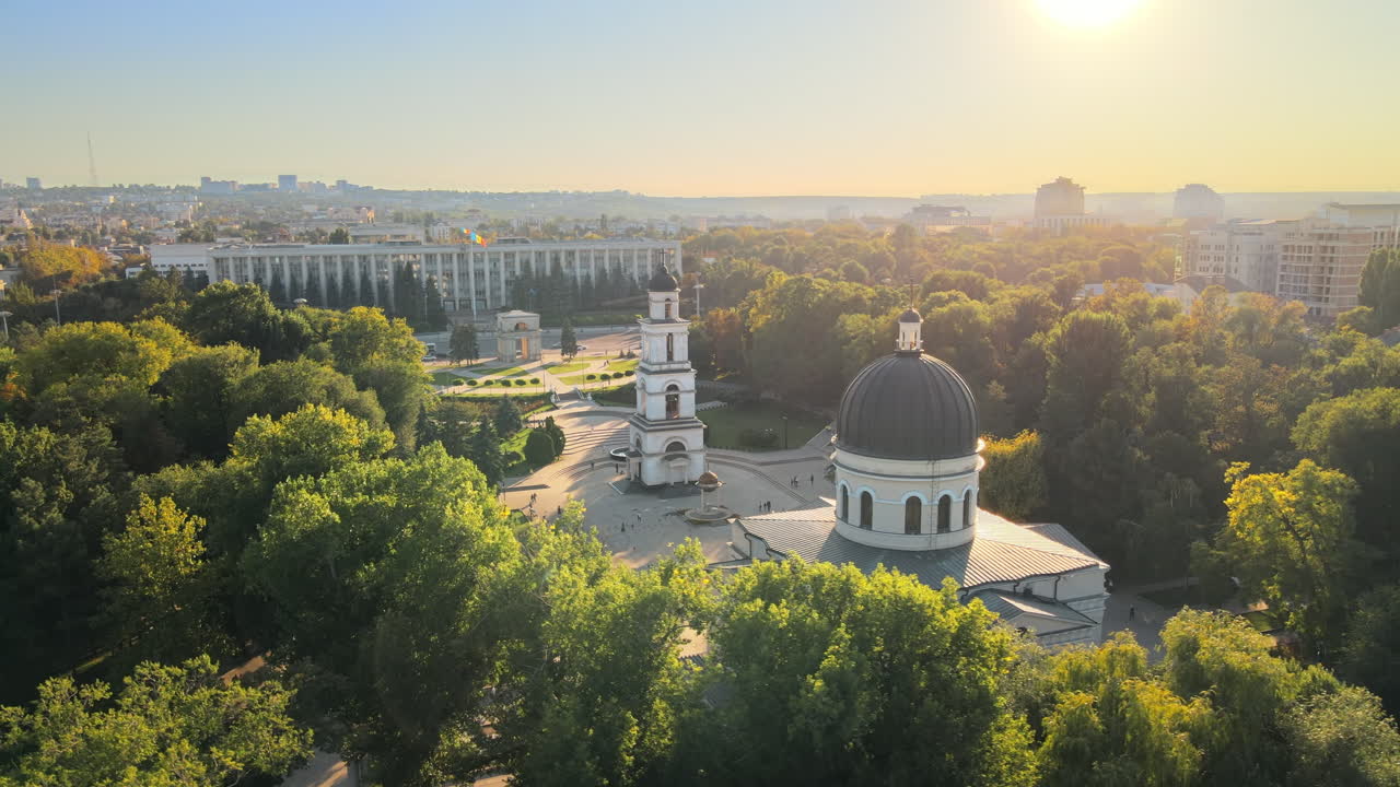 Aerial drone view of Chisinau downtown. Panorama view of central park, Cathedral, bell tower, a lot of greenery, walking people, buildings. Moldova