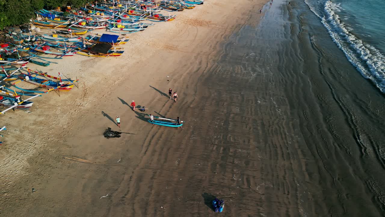 Jimbaran Bali coastal fishing village highlights wooden boats on the sand, wide shoreline, visitors by the sea, and a vibrant cultural atmosphere showcasing authentic island heritage