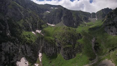 lush green malaiesti valley in the bucegi mountains on a sunny day, aerial view