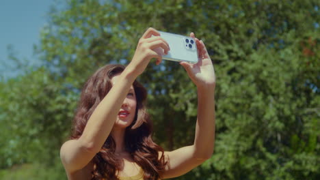 Woman-tourist-making-video-landscape-closeup.-Asian-girl-filming-park-view.