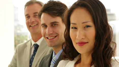 Business-team-smiling-at-camera-with-arms-crossed