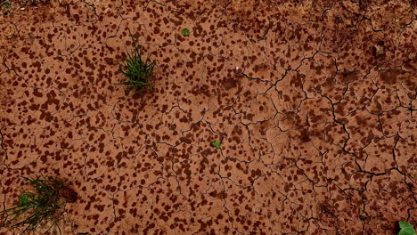 time lapse shot of raindrops falling on brown sandy ground during stormy day - close up top view