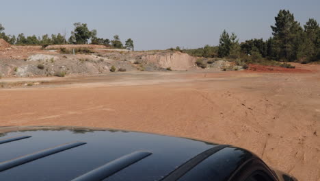 Car-roof-view-of-pickup-driving-through-abandonded-copper-min