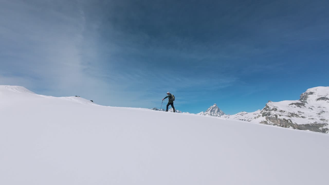 Dynamic POV shot climbing steep snowy mountain trail using trekking poles. Immersive first-person perspective of winter hiking adventure in alpine landscape, Italy. Aerial drone FPV, copy space