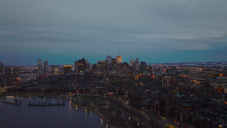 Aerial-panoramic-view-of-urban-neighbourhood-and-high-rise-office-buildings-in-background.-Evening-cityscape.-Boston,-USA