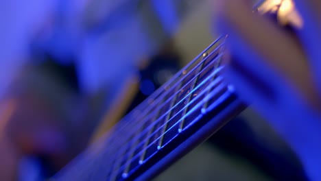 close up shot of musician's fingers performing skills on guitar's instrument