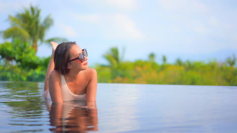 Close-up-of-a-pretty-young-woman-basks-in-a-resort-swimming-pool