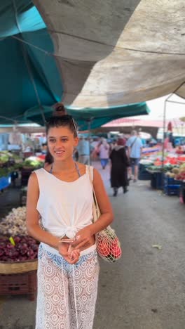 young woman shopping for produce at a market