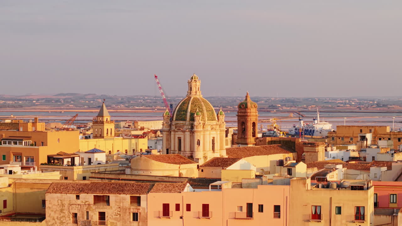 Scenic Trapani, Sicily at golden hour with historic buildings, dome view