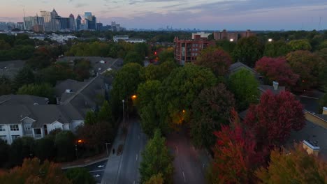 american homes at night with urban city skyscrapers in distance