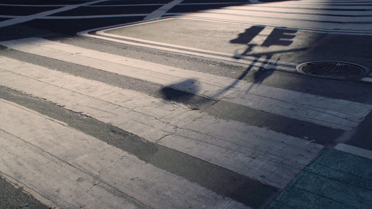 Close-up shot of a New York City crosswalk at sunrise