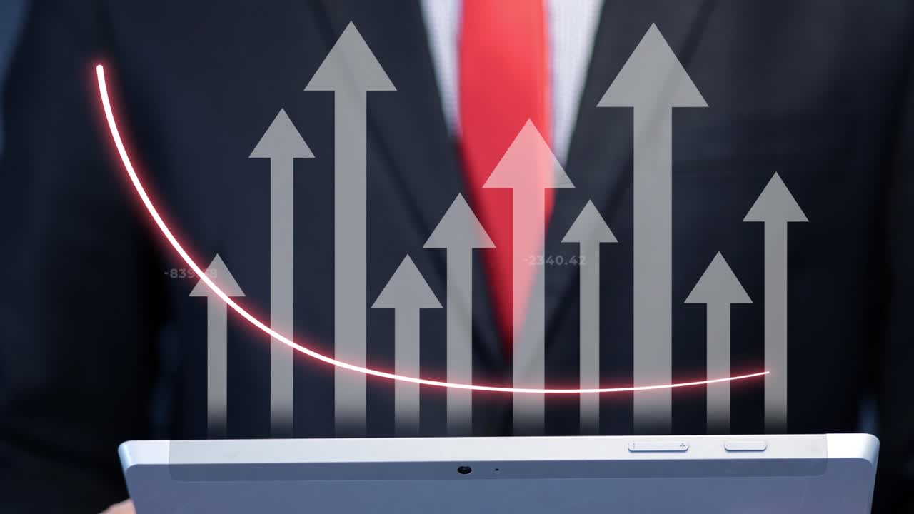 Businessman in a suit pointing at rising digital graphs and arrows holding a laptop with animation. Concept of financial success, market analysis and corporate growth