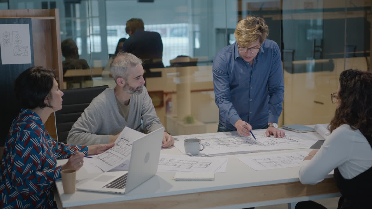 Mature Architects Discussing Floor Plans in the Office