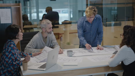 mature architects discussing floor plans in the office