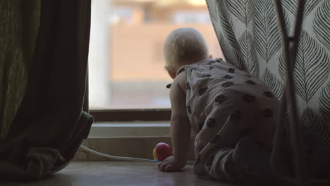 Baby-girl-is-interested-in-life-outside-the-window