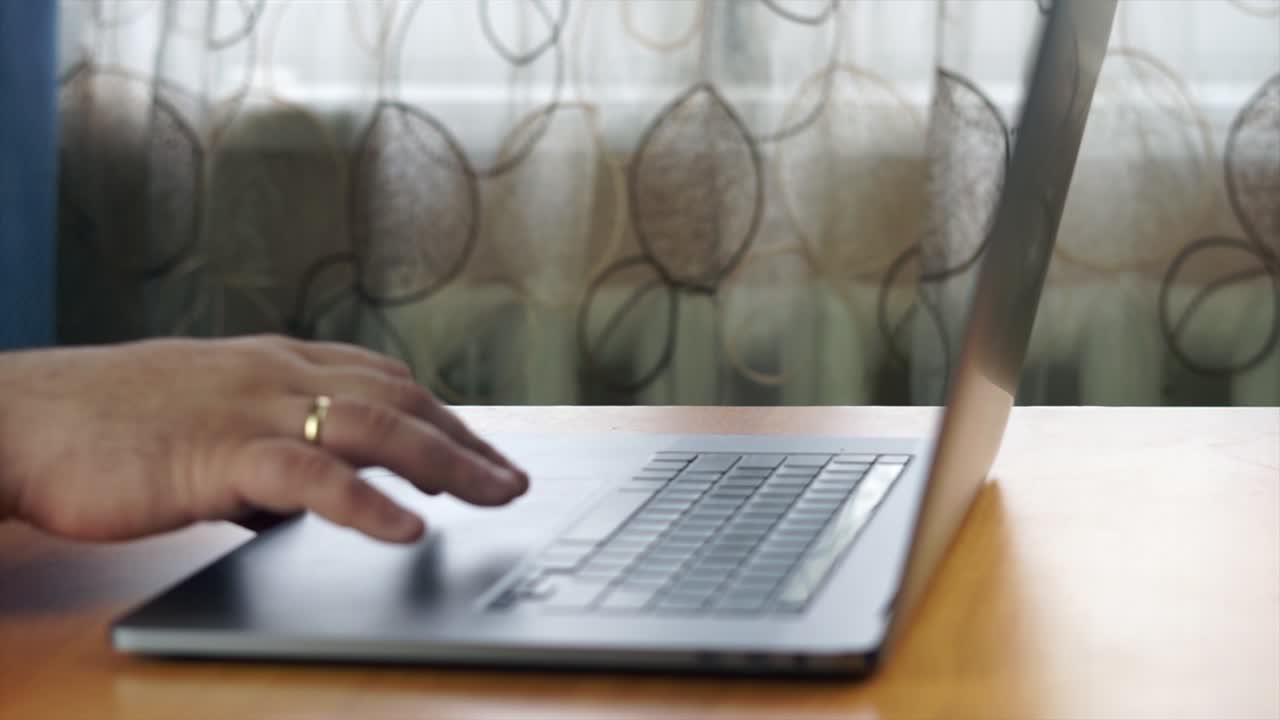 Hands of a businessman working on a laptop in the office. Closing