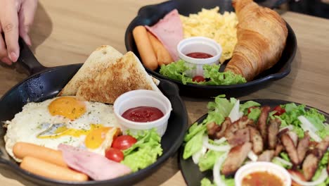 a hearty breakfast with eggs, ham, and salad