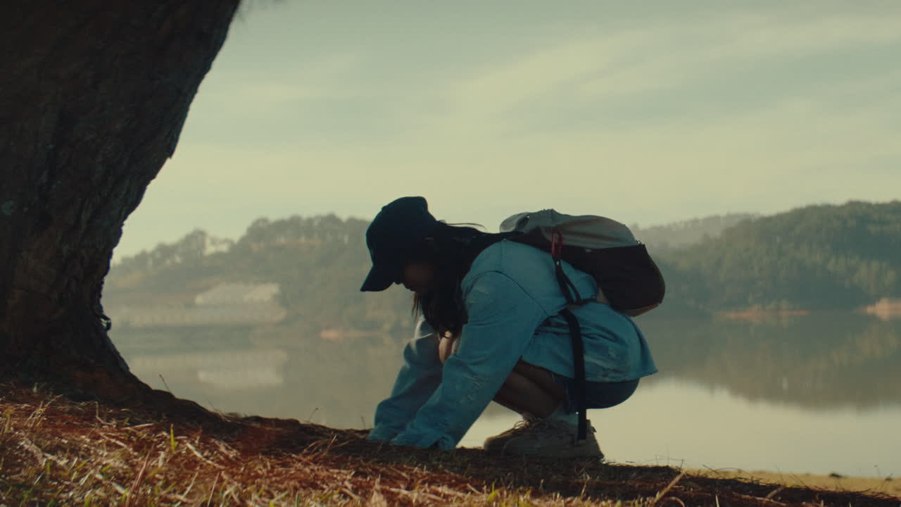 Woman Hiking by a Lake