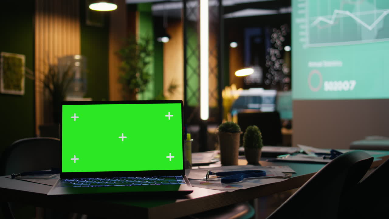 Sleek empty office with a laptop showcasing copy space at night