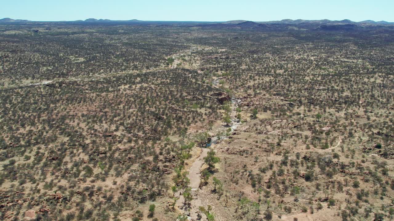 Aerial view of the dry and winding Todd River upstream of the Telegraph Station, north of Alice Springs, Mparntwe, Northern Territory, Australia. August 2022.
