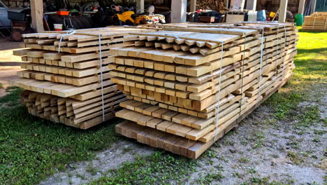 stack of teak wood boards ready for delivery at lumber yard. dolly-in shot