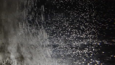 pill dissolving in water with air bubbles seen through transparent glass