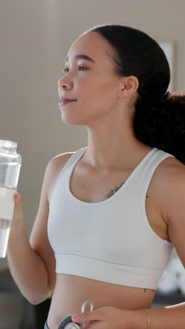 woman drinking water after workout