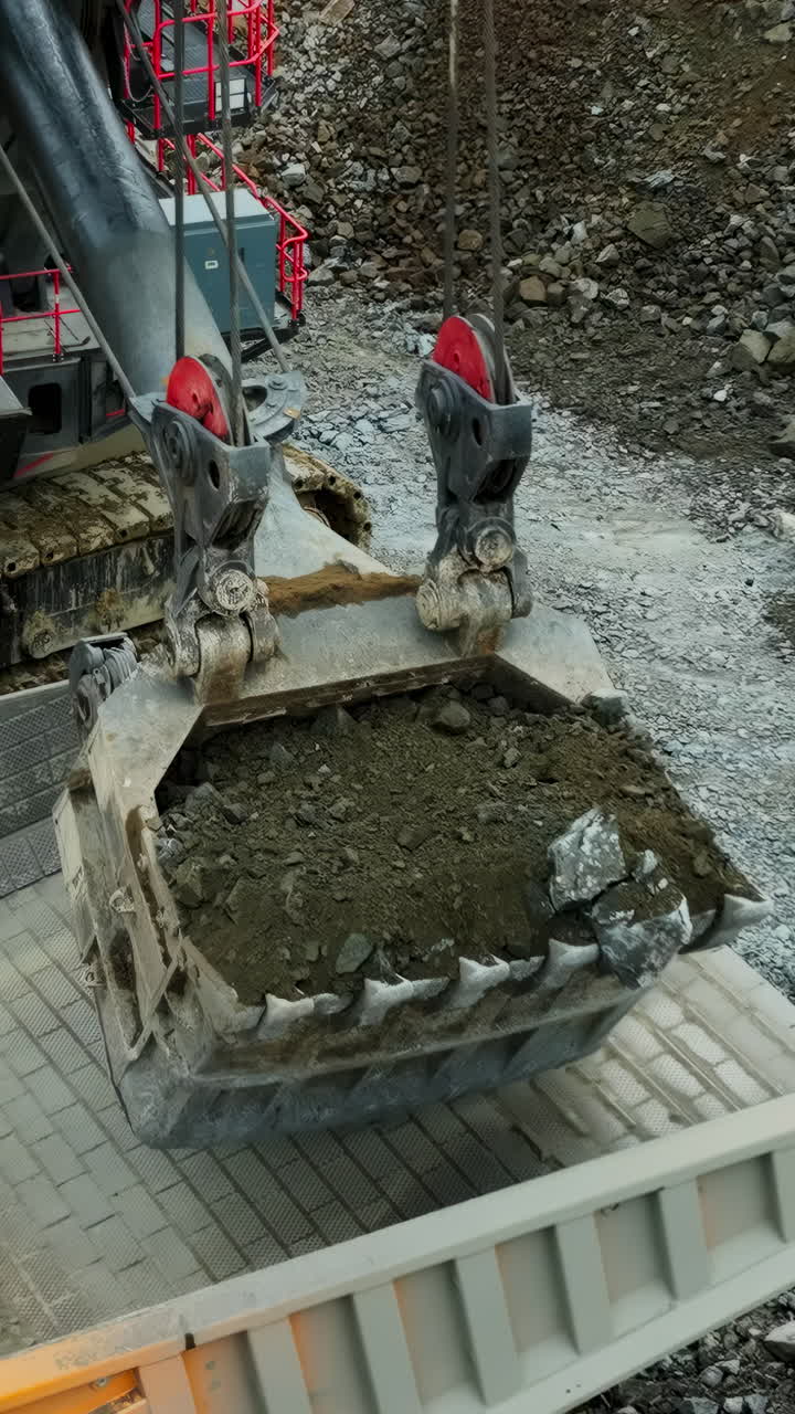 Excavator Filling Truck with Dirt and Gravel